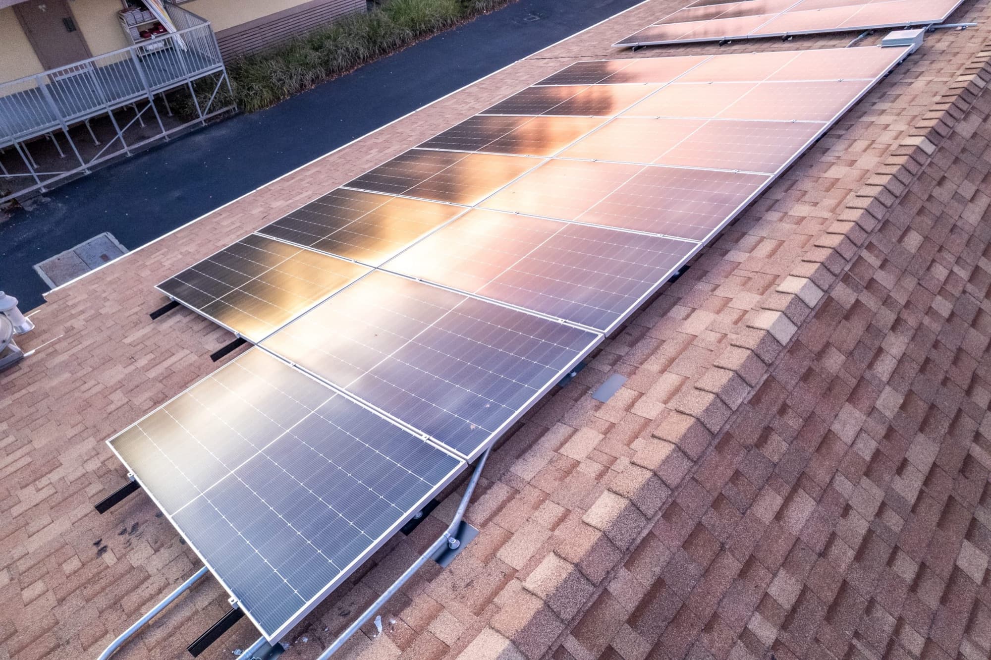 Clean residential solar panel array on a San Diego rooftop at sunset